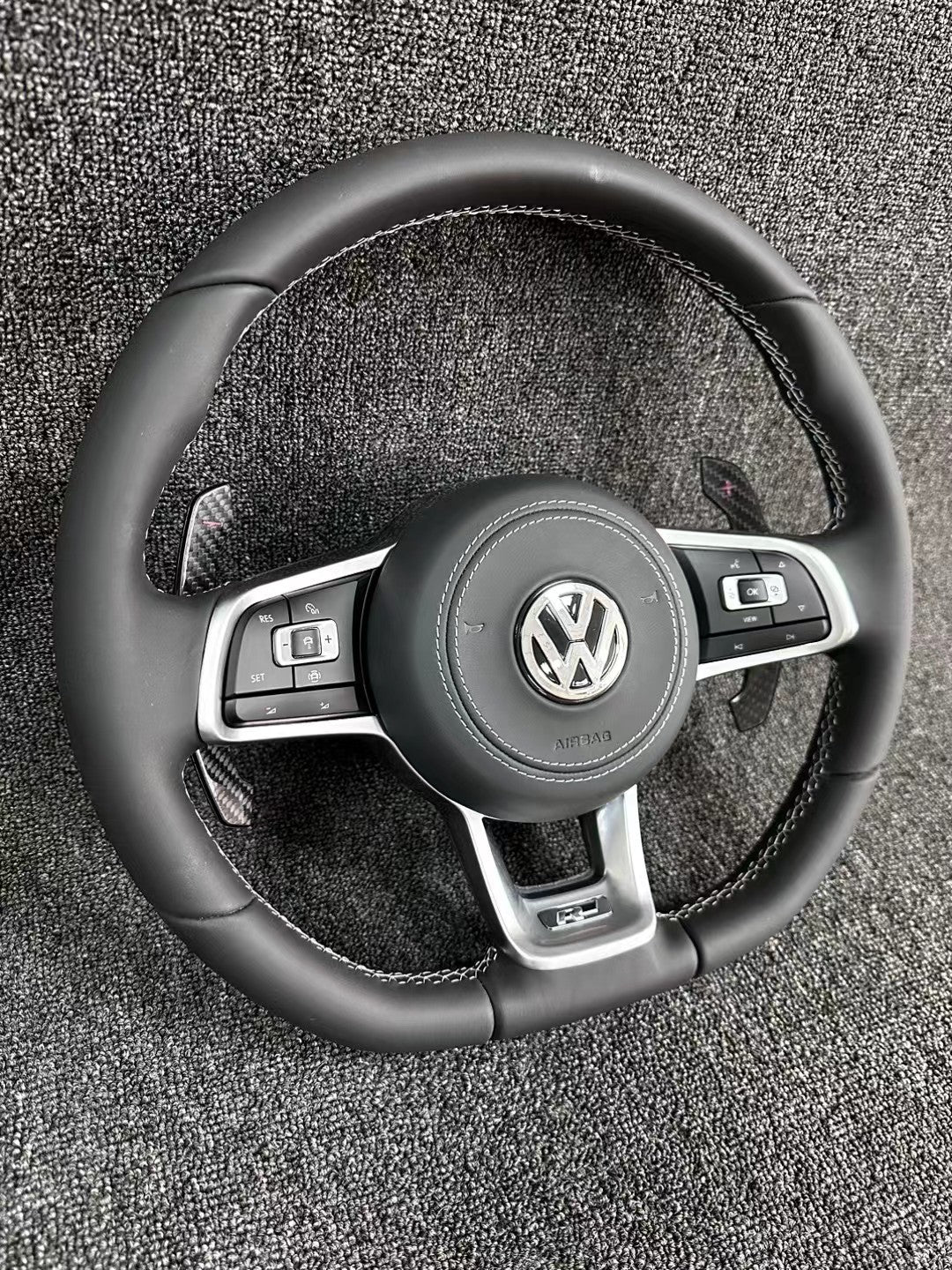 The all-new Volkswagen R line features a flat bottomed sport multifunction steering wheel with multifunctional buttons and carbon fiber paddles