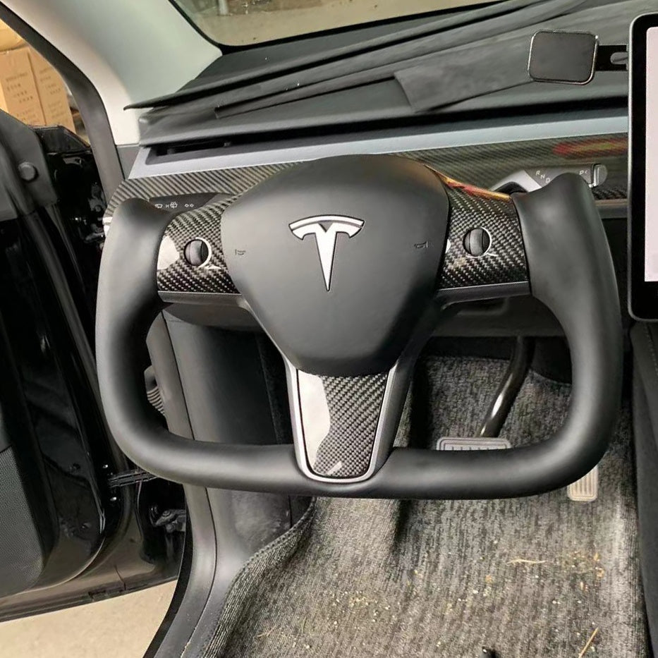 Yoke steering wheel with bright carbon or matte carbon trim with carbon side panels and heated custom speaker covers for Tesla Model 3/Y