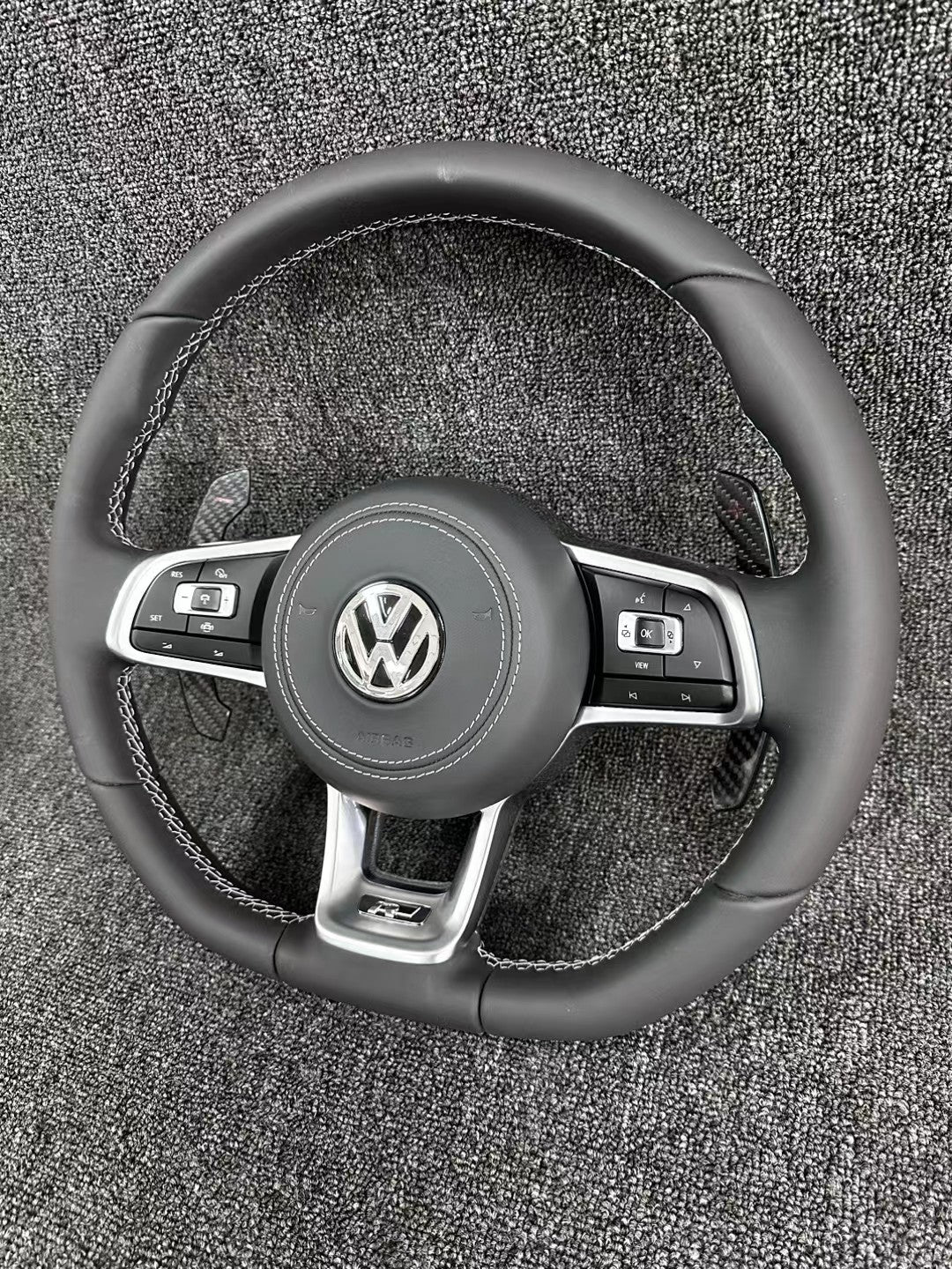 The all-new Volkswagen R line features a flat bottomed sport multifunction steering wheel with multifunctional buttons and carbon fiber paddles
