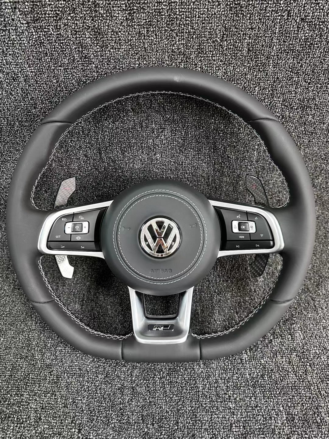 The all-new Volkswagen R line features a flat bottomed sport multifunction steering wheel with multifunctional buttons and carbon fiber paddles