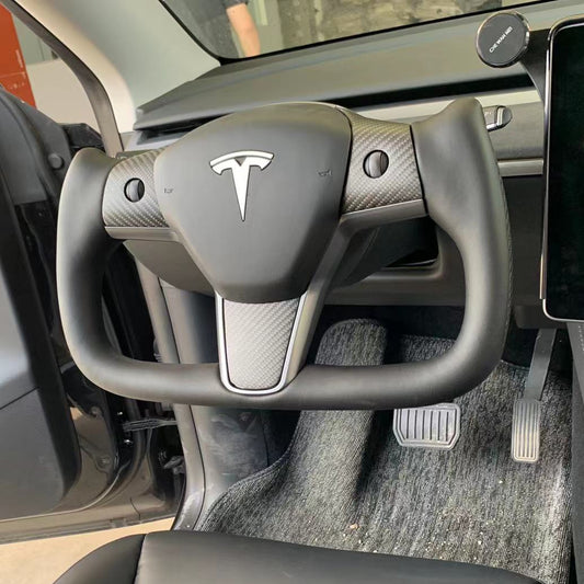Yoke steering wheel with bright carbon or matte carbon trim with carbon side panels and heated custom speaker covers for Tesla Model 3/Y