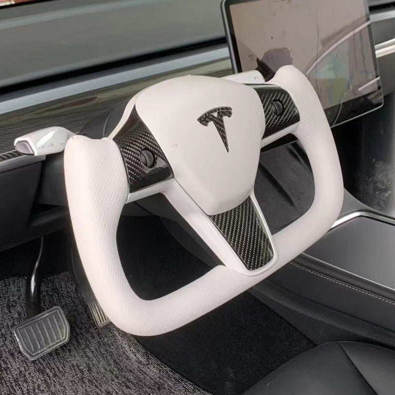 Yoke steering wheel with bright carbon or matte carbon trim with carbon side panels and heated custom speaker covers for Tesla Model 3/Y