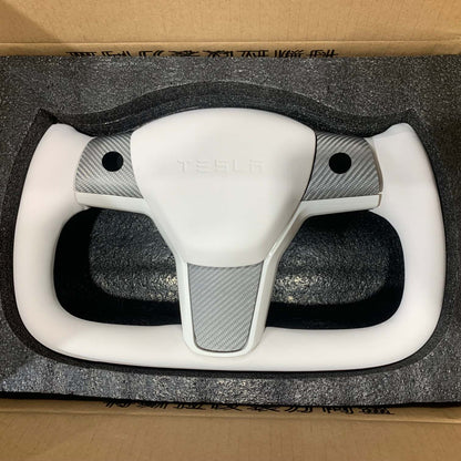 Yoke steering wheel with bright carbon or matte carbon trim with carbon side panels and heated custom speaker covers for Tesla Model 3/Y